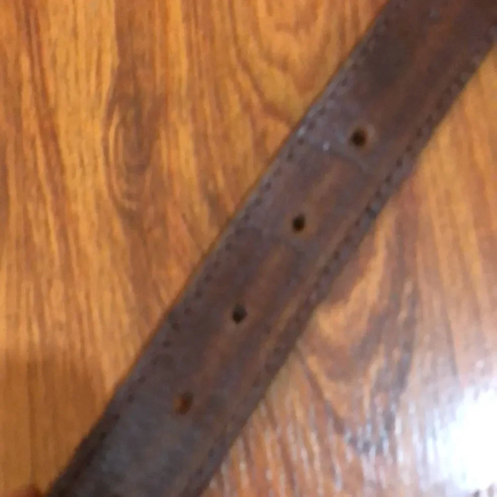 Brighton style genuine leather brown belt with silver detail.